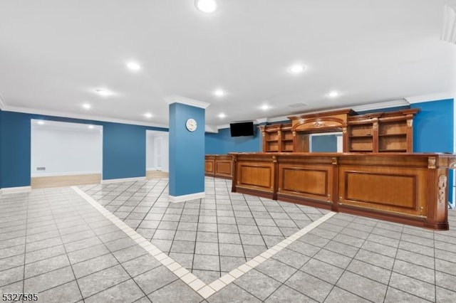 kitchen with crown molding and light tile patterned flooring