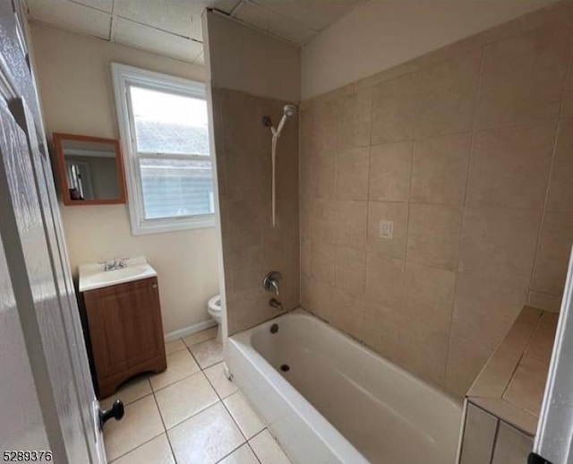 full bathroom featuring toilet, vanity, tile patterned flooring, and tiled shower / bath