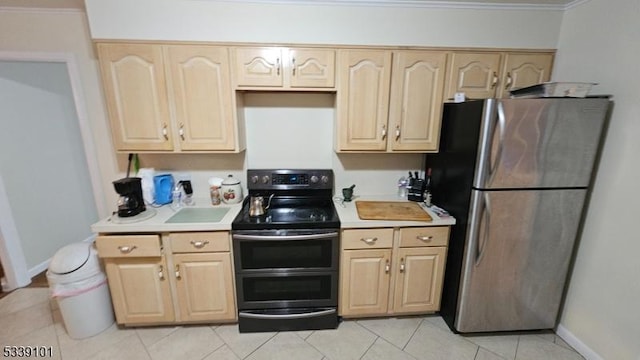 kitchen featuring appliances with stainless steel finishes, light tile patterned floors, crown molding, and light brown cabinetry