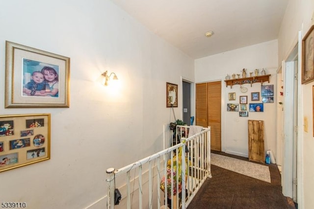 hallway featuring an upstairs landing