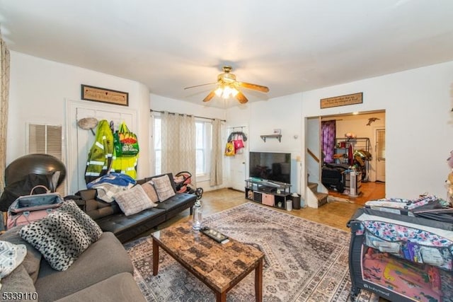 living room with stairs and ceiling fan