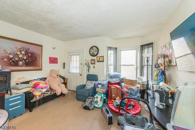 rec room featuring carpet and a textured ceiling