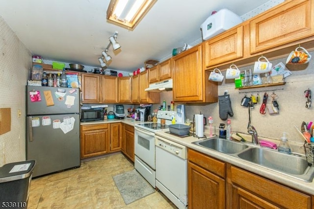 kitchen with white appliances, light countertops, a sink, and under cabinet range hood