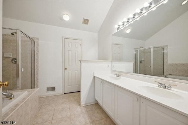 full bath featuring a bath, double vanity, visible vents, and a sink