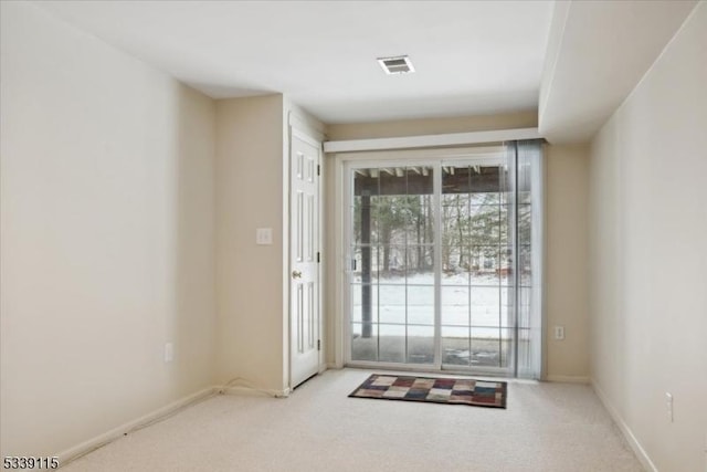 doorway with light colored carpet, visible vents, and baseboards