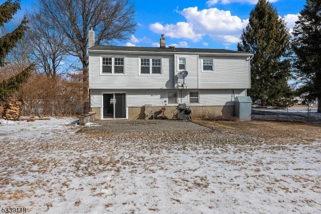 view of front of home with a chimney and fence