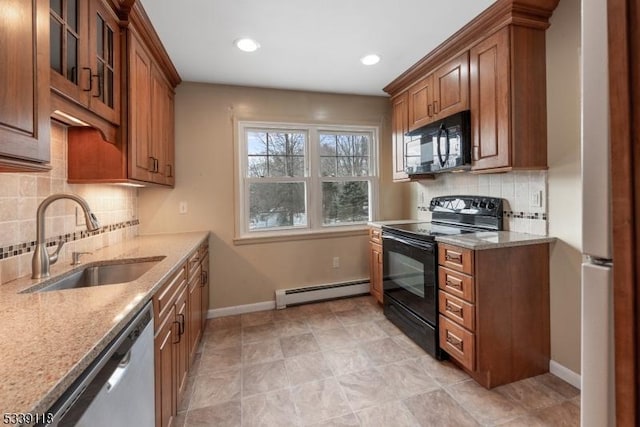 kitchen with baseboard heating, brown cabinets, a sink, and black appliances