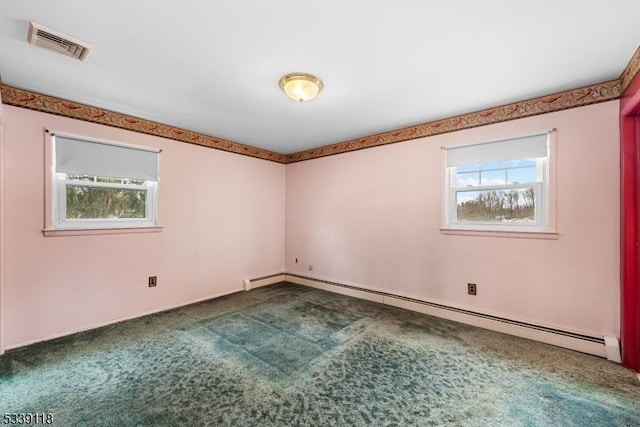 empty room with a baseboard radiator, a healthy amount of sunlight, visible vents, and carpet flooring