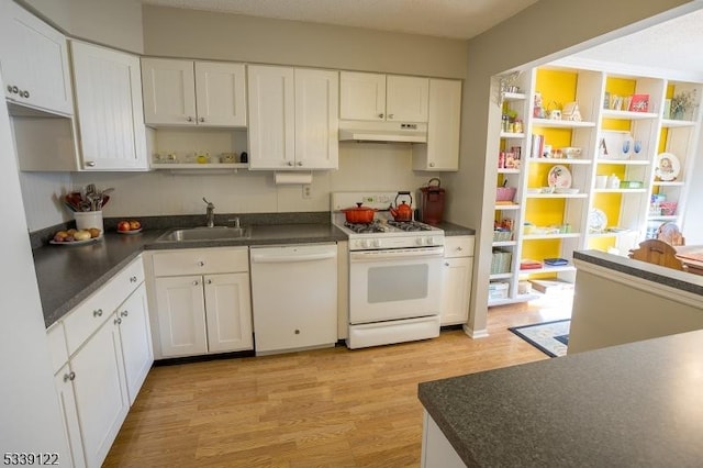 kitchen with open shelves, dark countertops, a sink, white appliances, and under cabinet range hood