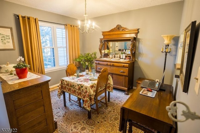 dining area featuring an inviting chandelier and baseboards