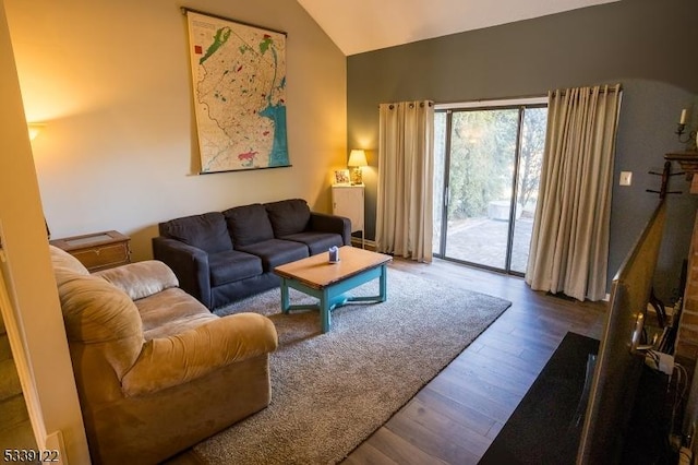 living area featuring lofted ceiling and wood finished floors