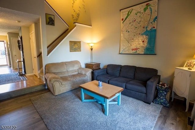 living area with stairs and wood finished floors