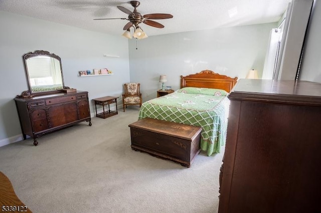 bedroom with light carpet, ceiling fan, a textured ceiling, and baseboards