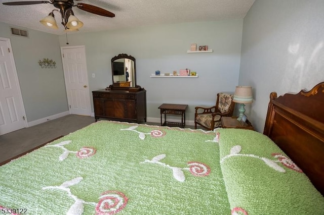 carpeted bedroom featuring baseboards, visible vents, ceiling fan, and a textured ceiling