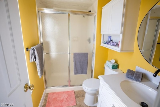 bathroom featuring a stall shower, vanity, and toilet