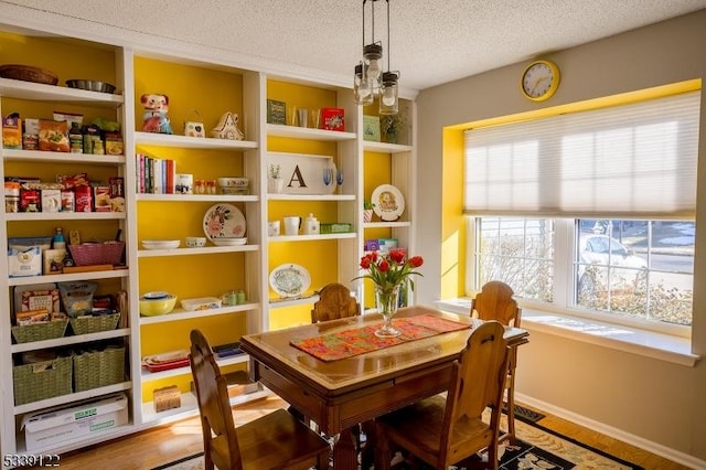 game room featuring baseboards and a textured ceiling