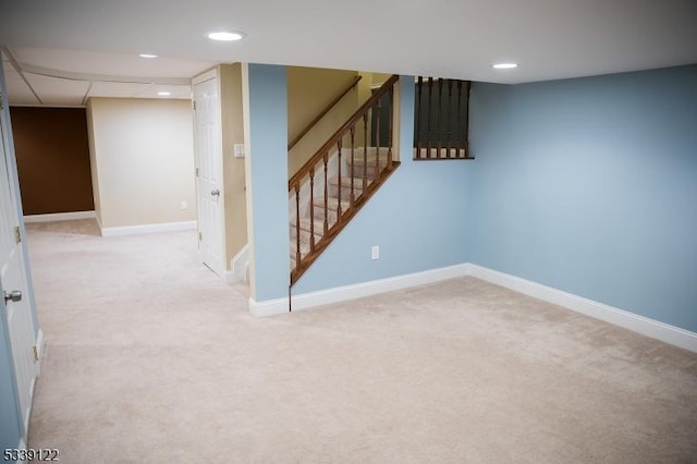 finished below grade area with carpet floors, stairway, and baseboards