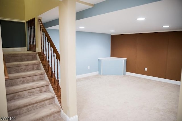 staircase featuring carpet floors, baseboards, and recessed lighting