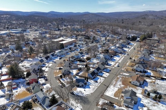 snowy aerial view with a mountain view