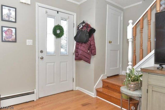 entryway featuring light hardwood / wood-style flooring, crown molding, and baseboard heating