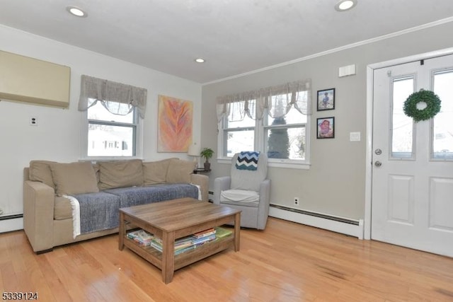 living room featuring a baseboard radiator, crown molding, and light hardwood / wood-style flooring