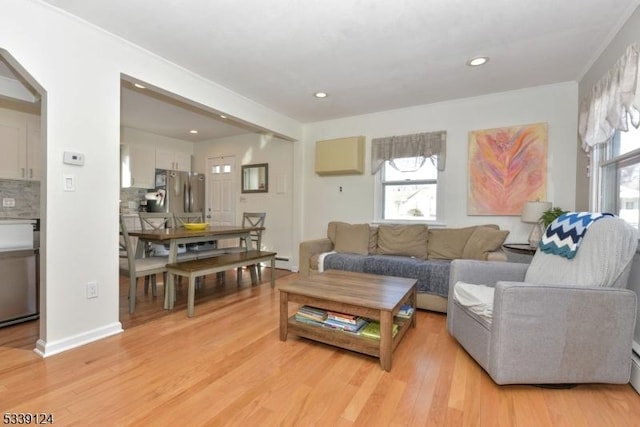 living room featuring light wood-type flooring and baseboard heating