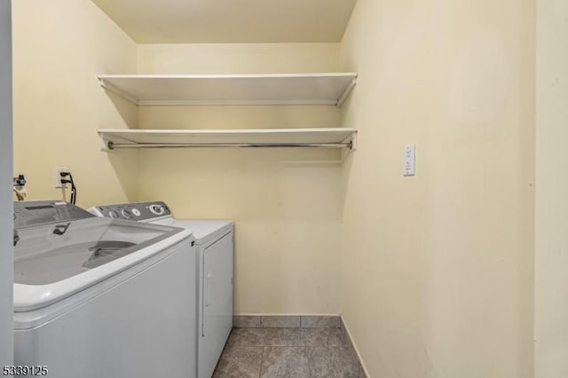 washroom with washing machine and dryer and tile patterned flooring