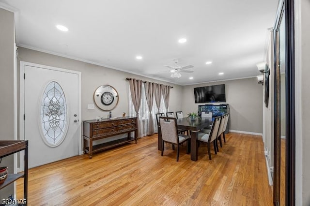 dining room featuring light wood-type flooring, crown molding, and ceiling fan