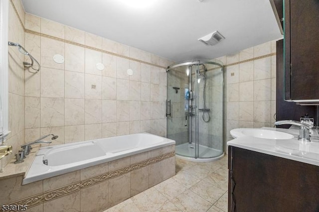 bathroom featuring independent shower and bath, tile walls, and vanity