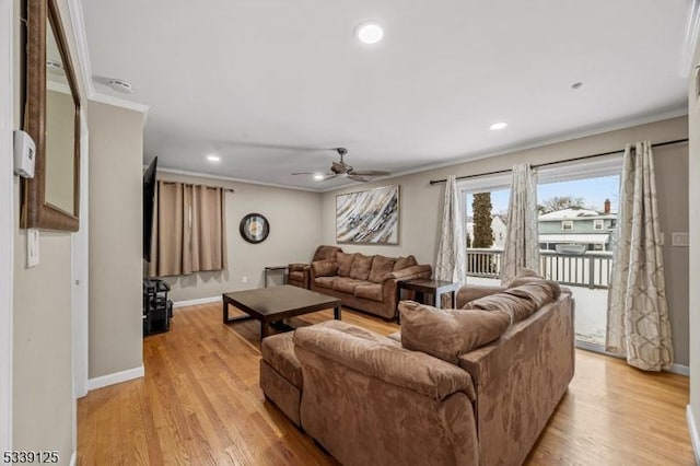 living room featuring ornamental molding, ceiling fan, and light hardwood / wood-style flooring