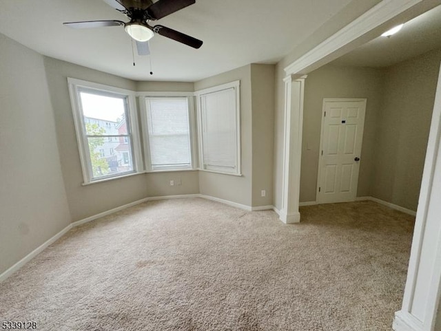 empty room featuring light carpet and ceiling fan