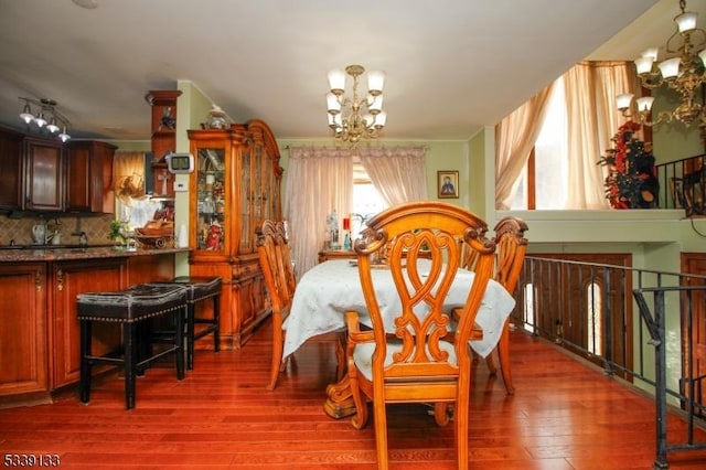 dining room with an inviting chandelier and wood finished floors