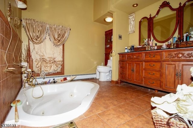 bathroom with toilet, tile patterned flooring, vanity, and a whirlpool tub