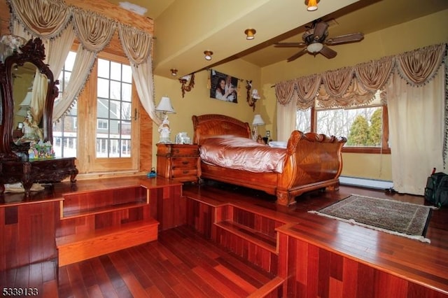 bedroom with a baseboard radiator and wood finished floors