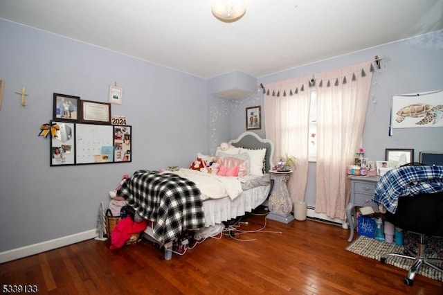 bedroom featuring wood finished floors and baseboards