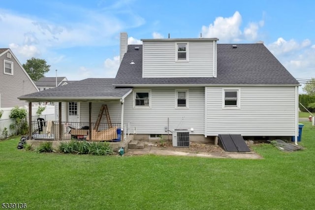 166 E Camplain Rd, Manville Boro, NJ 08835 - back of house featuring a yard, central AC, a shingled roof, and a chimney