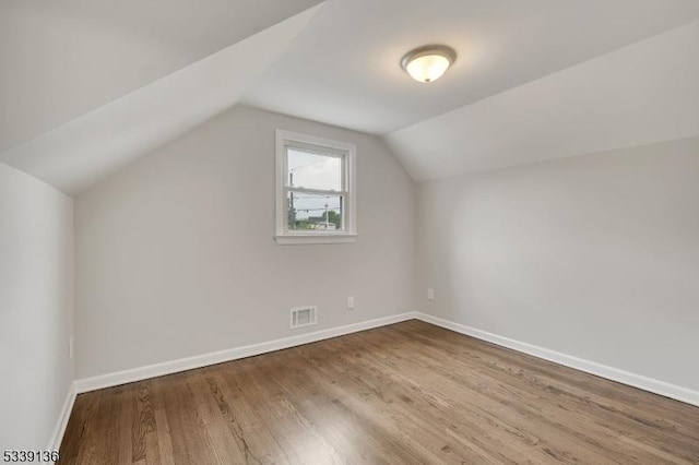 166 E Camplain Rd, Manville Boro, NJ 08835 - additional living space with wood finished floors, vaulted ceiling, and baseboards