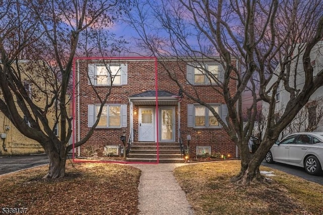 multi unit property featuring entry steps and brick siding