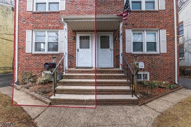 doorway to property with brick siding