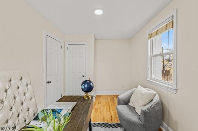 living area with wood finished floors and baseboards