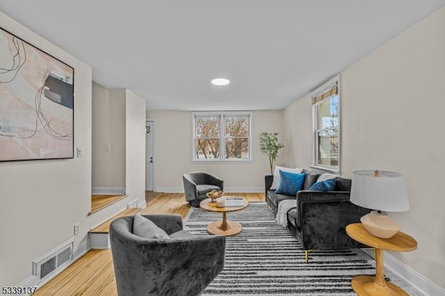 sitting room featuring light wood finished floors, baseboards, and visible vents