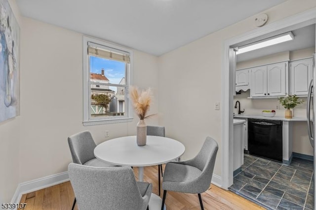 dining space featuring dark wood-style floors and baseboards