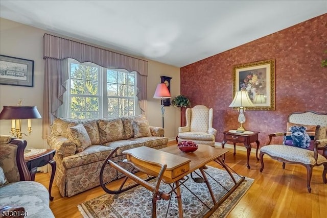 living area with baseboards and light wood finished floors