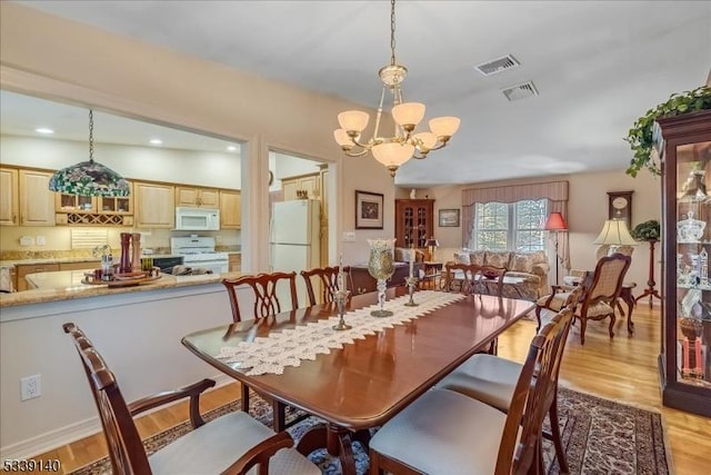 dining area with an inviting chandelier, recessed lighting, visible vents, and light wood-type flooring