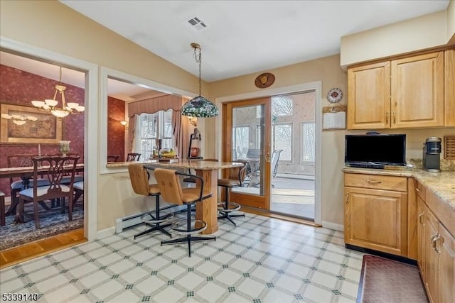 dining room featuring vaulted ceiling, plenty of natural light, light floors, and visible vents