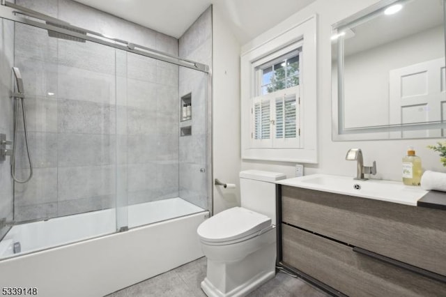 bathroom with shower / bath combination with glass door, vanity, and toilet