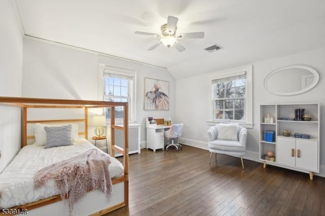 bedroom with multiple windows, vaulted ceiling, visible vents, and hardwood / wood-style floors