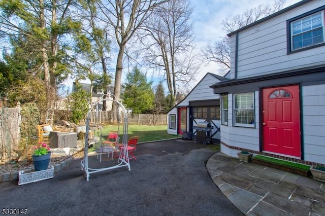 view of yard featuring fence and a patio