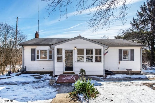 bungalow-style house featuring a chimney