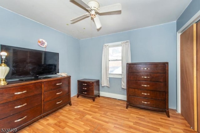 bedroom featuring light wood-type flooring, ceiling fan, and baseboards